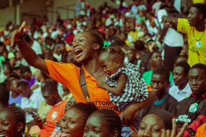 Lively scene of a diverse crowd enjoying a vibrant event at a stadium, capturing community spirit.