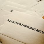 Brown paper envelopes featuring startup text, symbolizing business innovation and entrepreneurship.