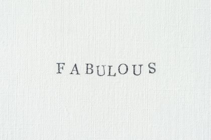 Simple textured paper featuring the word 'FABULOUS' in a clean typewriter font.