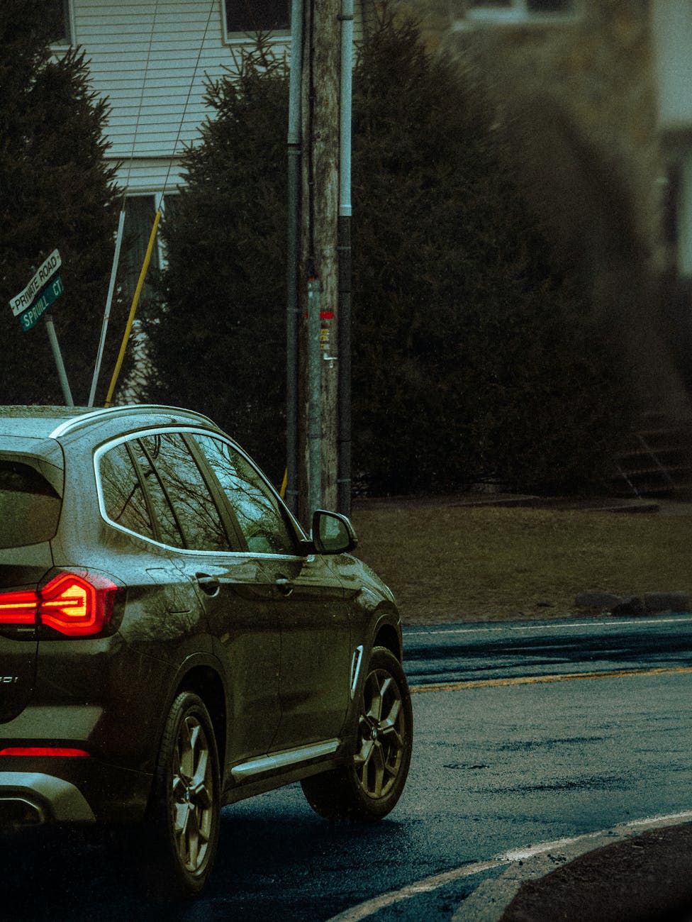 A car navigates rainy city streets in Monsey, NY, showcasing an urban vibe.