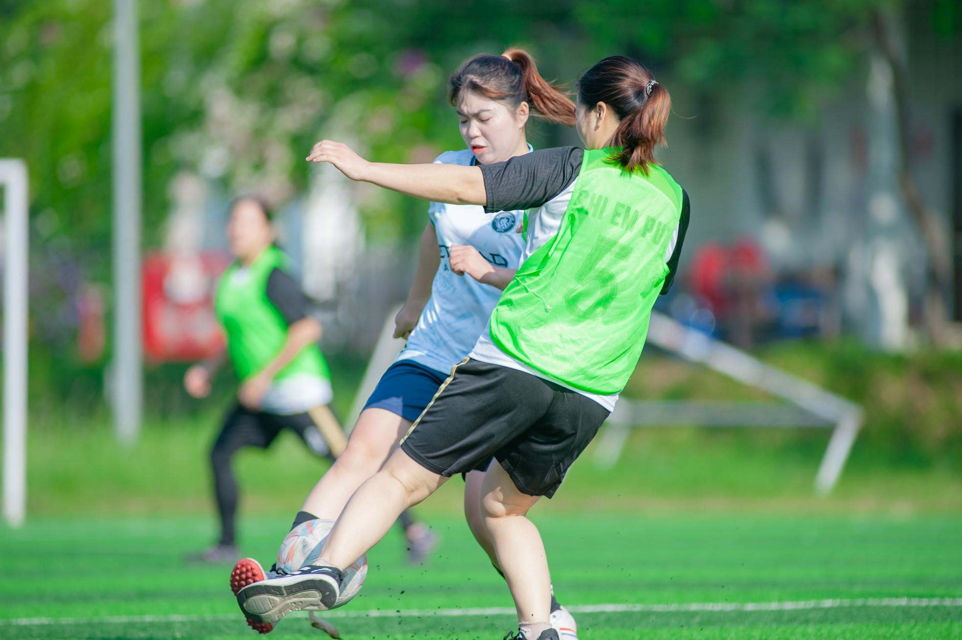Intense soccer match between women in Hà Nội, Vietnam captured in action.