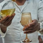 A close-up of a festive champagne pour at a celebration in Yaoundé, Cameroon.