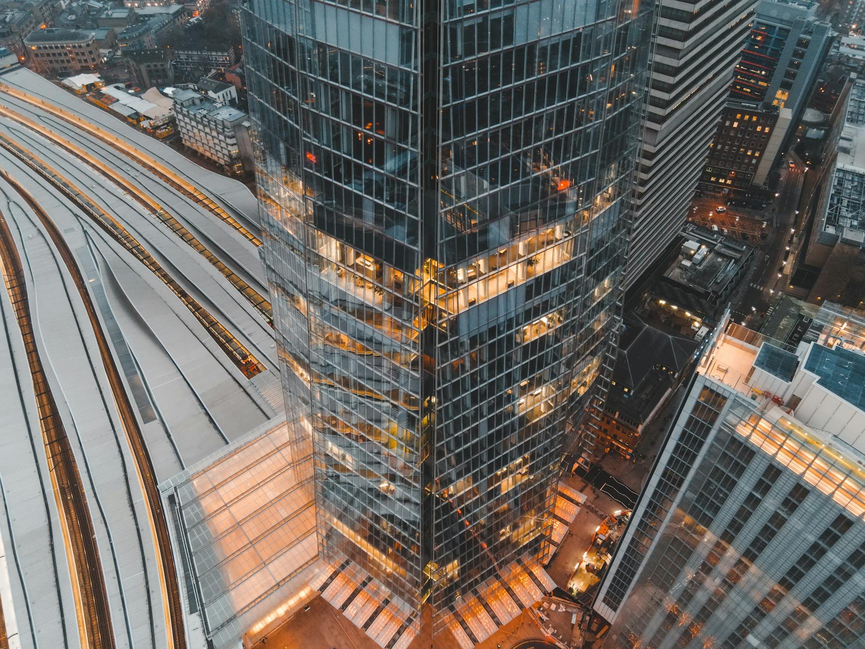Drone view of London city located in England with tall Shard skyscraper near buildings and railways in daytime