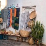 Colorful scarfs and handmade baskets displayed in Asilah, Morocco.