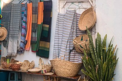 Colorful scarfs and handmade baskets displayed in Asilah, Morocco.